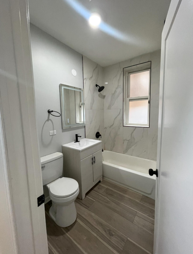 1227 South Springfield Avenue, Unit 1 Chicago, IL 60623 - Photo 6 of 6 a bathroom with a toilet a sink and bathtub