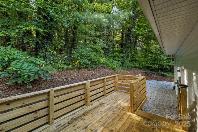 a view of a backyard with wooden fence