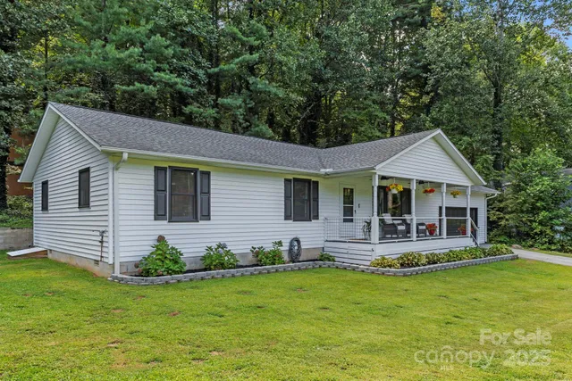 a front view of a house with a yard table and chairs