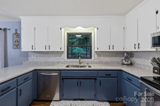 a kitchen with a sink cabinets and window