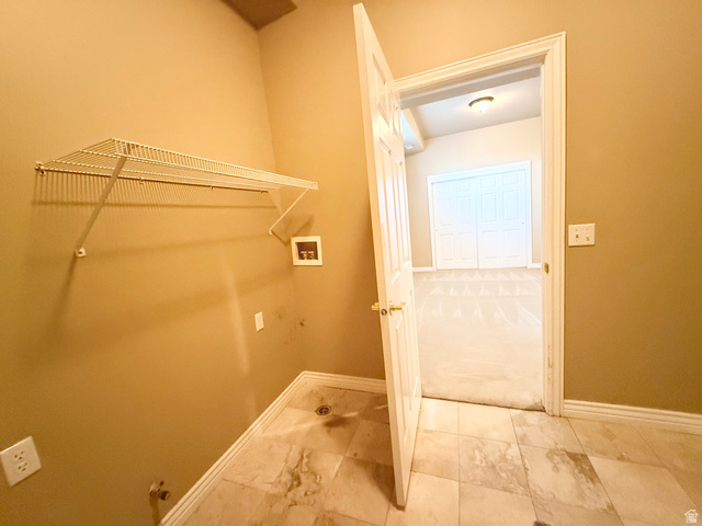 1562 Fairway Ridge Road Draper, UT 84020 - Photo 47 of 60 Utility area featuring tile flooring, a wall-mounted wire shelf, and washer/dryer hookups