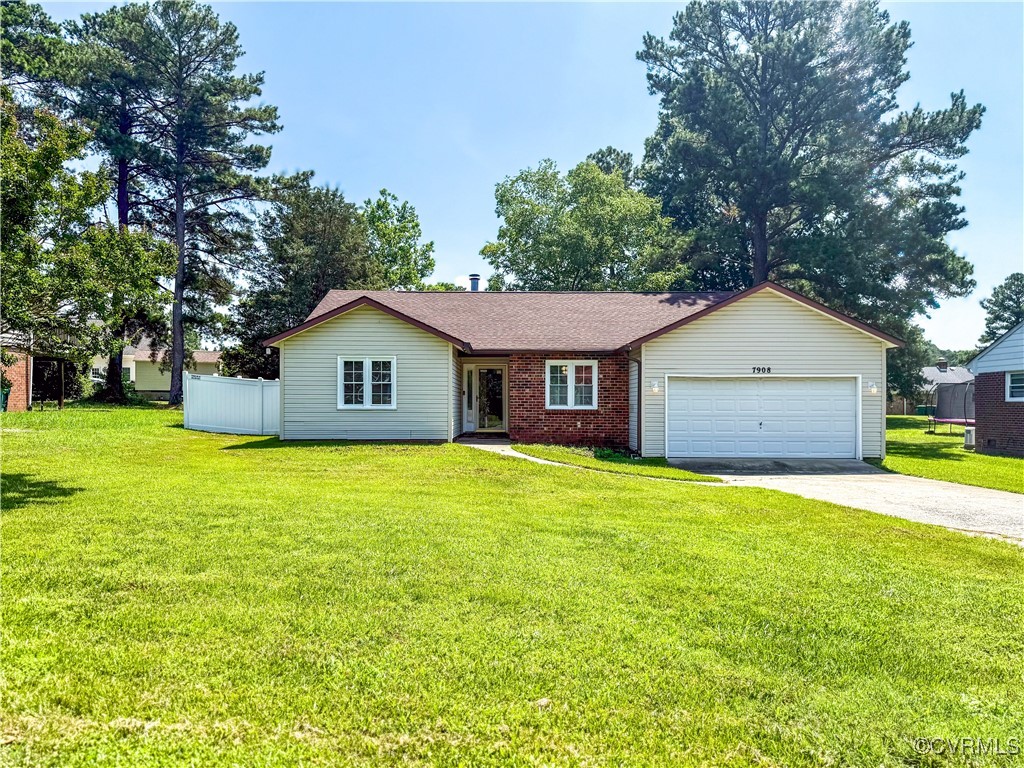 a front view of a house with yard and green space
