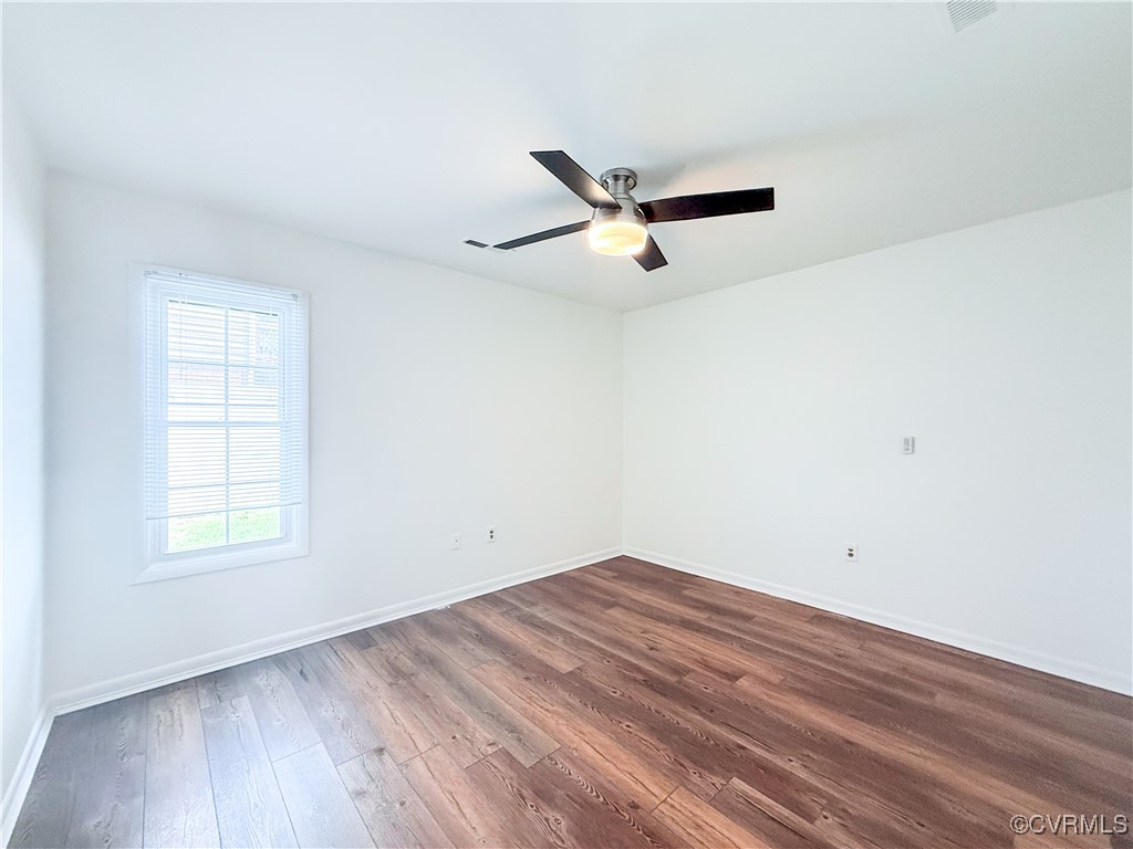 7908 Capistrano Drive Richmond, VA 23227 - Photo 11 of 22 an empty room with wooden floor and windows