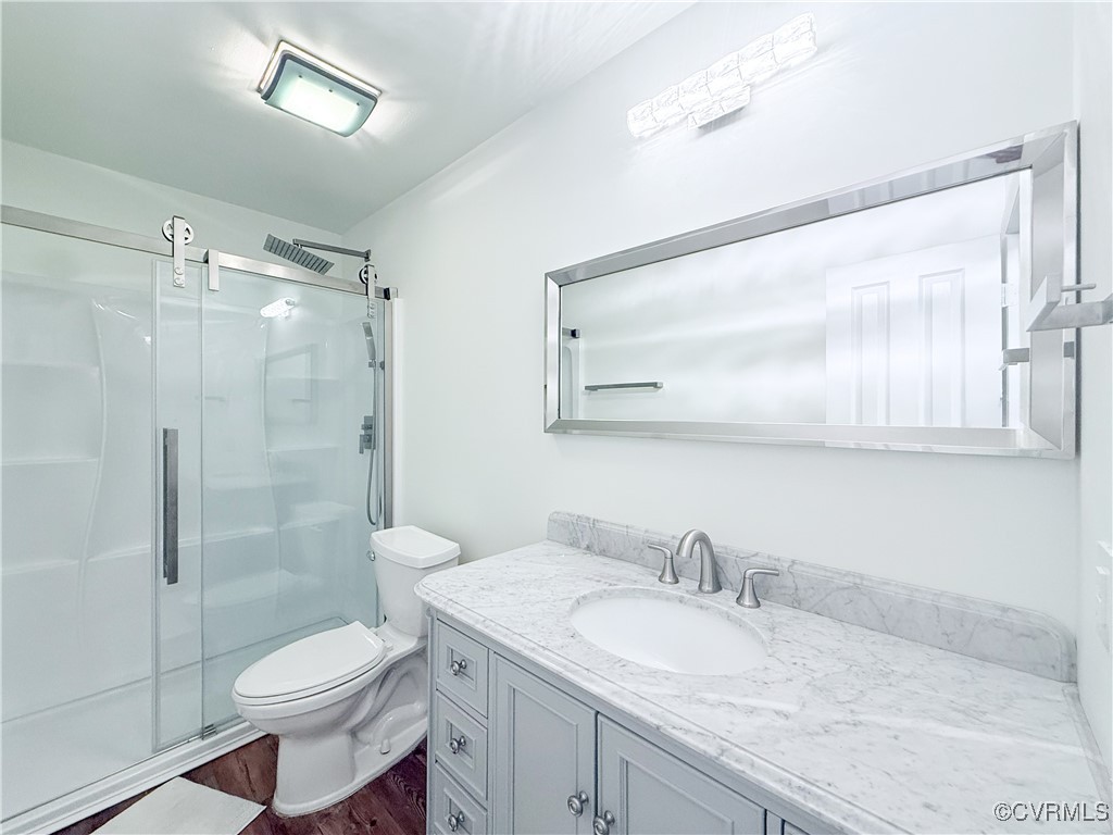 7908 Capistrano Drive Richmond, VA 23227 - Photo 13 of 22 a bathroom with a granite countertop sink toilet and shower