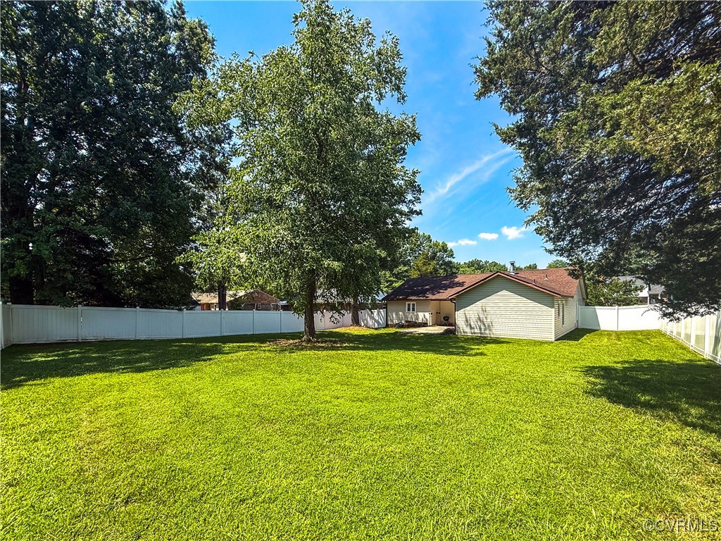 7908 Capistrano Drive Richmond, VA 23227 - Photo 17 of 22 a view of a house with a big yard and large trees
