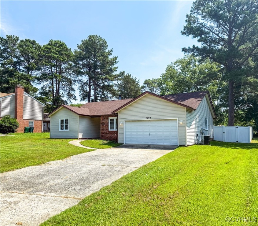 7908 Capistrano Drive Richmond, VA 23227 - Photo 21 of 22 a front view of a house with a yard and garage