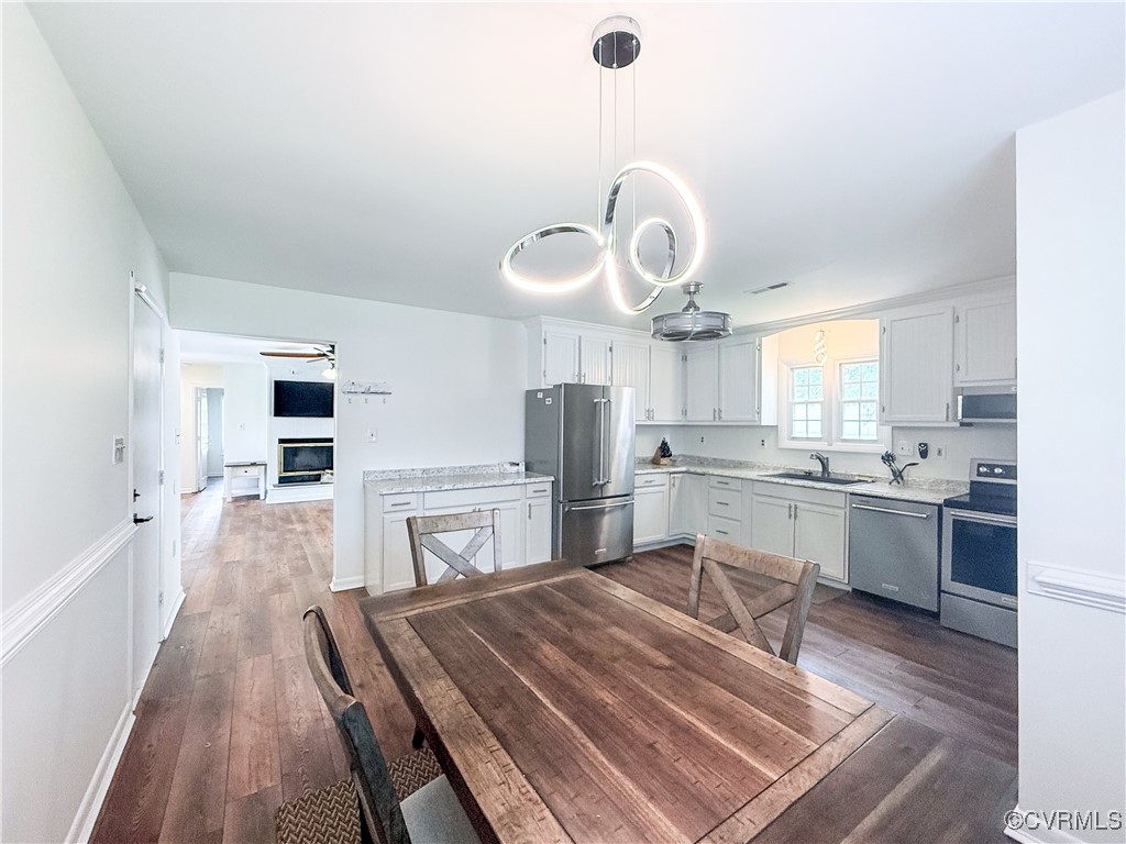 7908 Capistrano Drive Richmond, VA 23227 - Photo 5 of 22 a large kitchen with a table and chairs in it