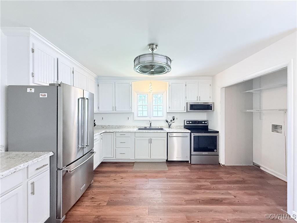 7908 Capistrano Drive Richmond, VA 23227 - Photo 6 of 22 a kitchen with granite countertop a refrigerator stove top oven and sink