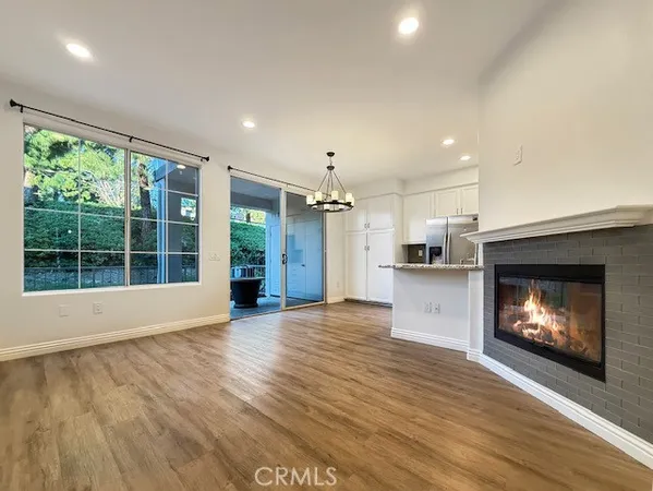 a view of an empty room with a fireplace and a window