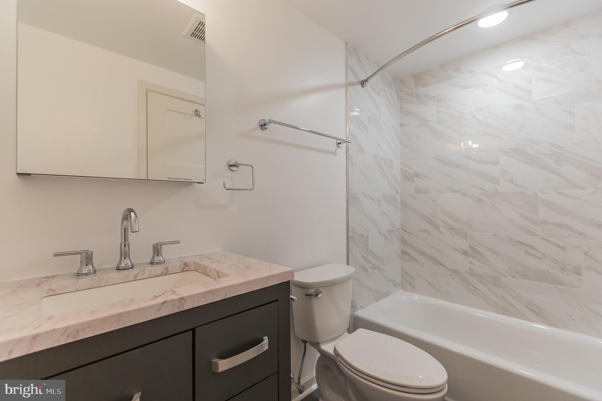 6778 Ridge Avenue, Unit 306 Philadelphia, PA 19128 - Photo 4 of 6 a bathroom with a sink toilet vanity and shower