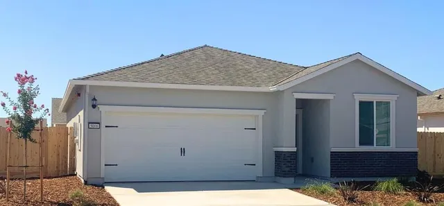 a kitchen with a refrigerator a stove top oven a sink and dishwasher with wooden floor