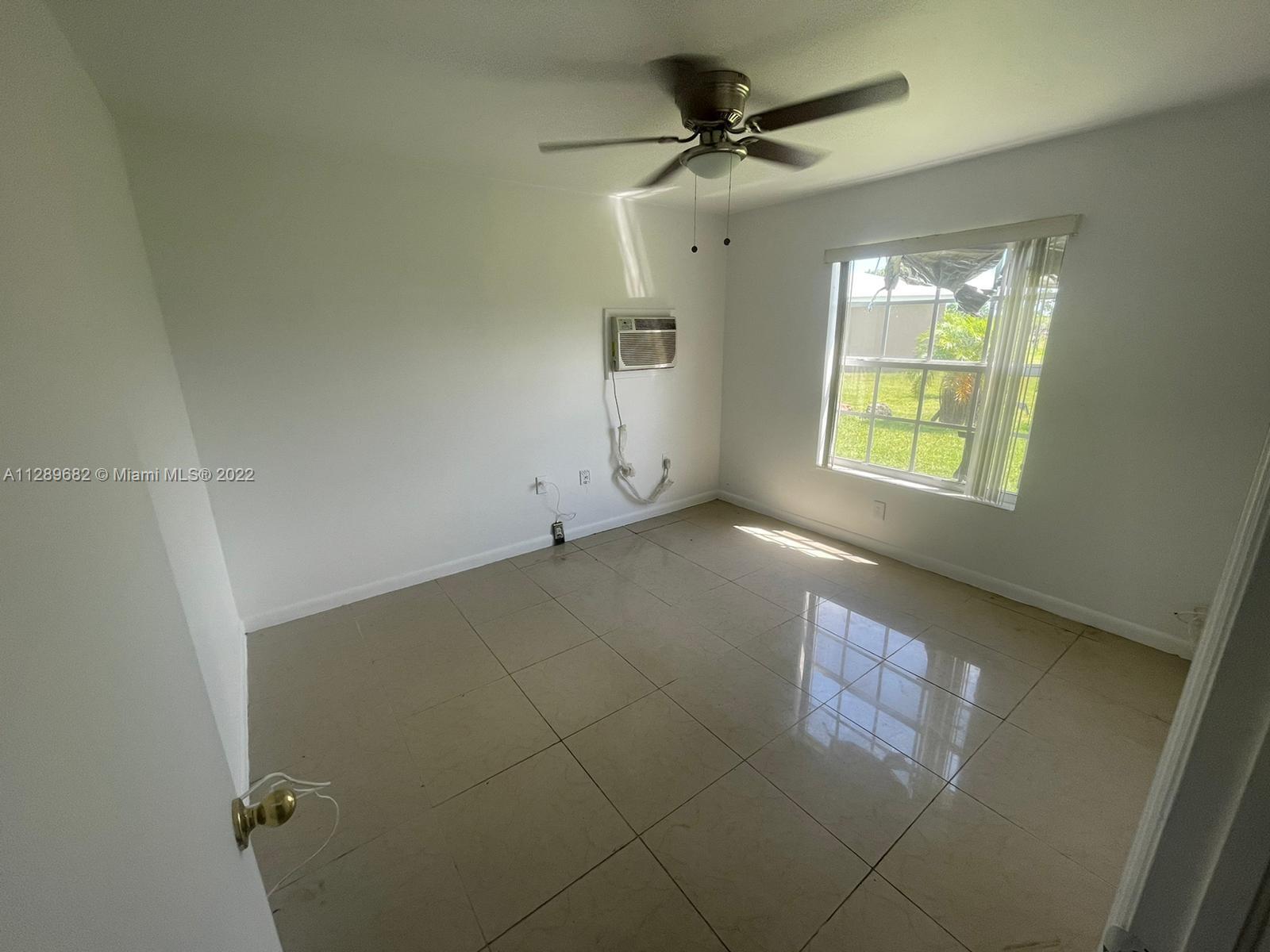 Goulds Miami, FL 33170 - Photo 1 of 4 an empty room with a empty space and windows