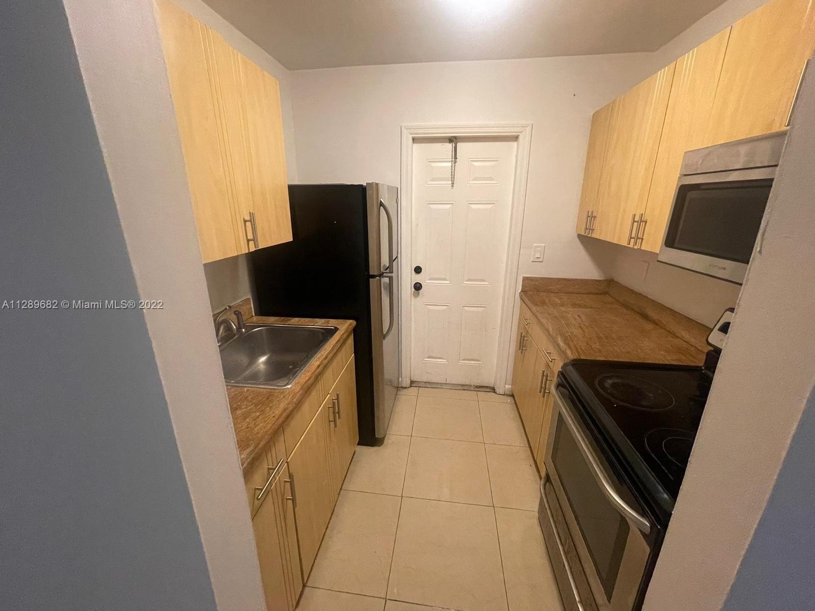 Goulds Miami, FL 33170 - Photo 2 of 4 a kitchen with a refrigerator stove and sink