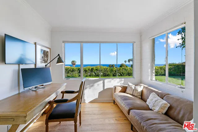 a living room with furniture rug and lamp