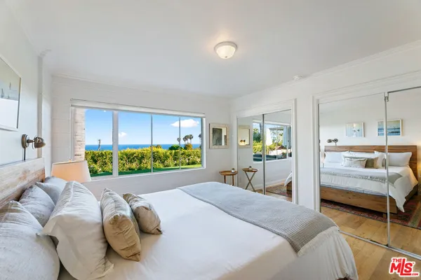 a bedroom with a bed and a view of bedroom