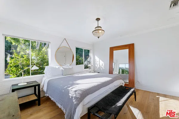 a bedroom with a bed and a mirror