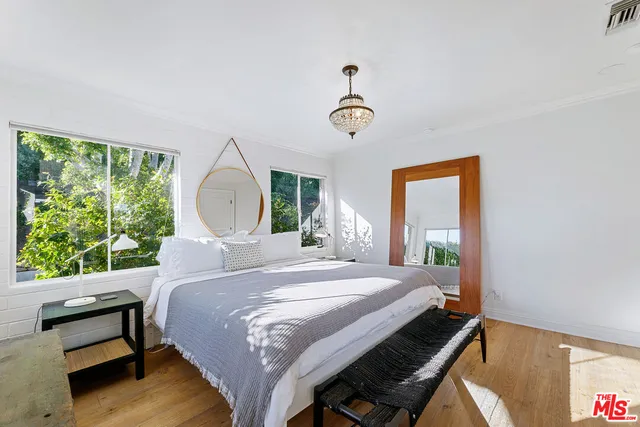 a bedroom with a bed and a mirror