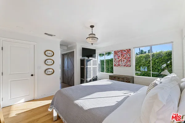 a bedroom with a bed dresser and a window