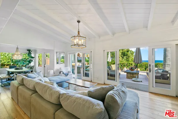 a living room with furniture and a chandelier
