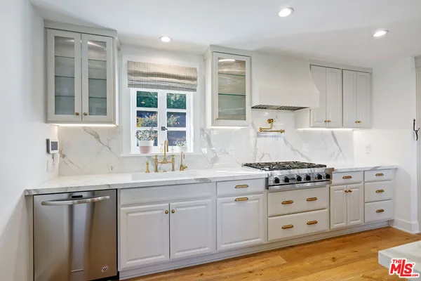 a kitchen with cabinets appliances and a window