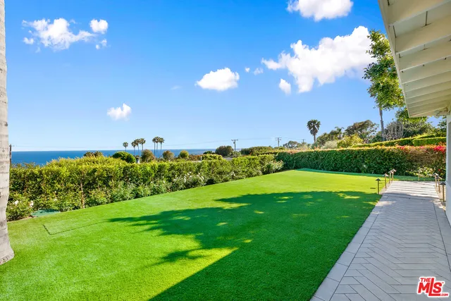 a view of a big yard with flower plants