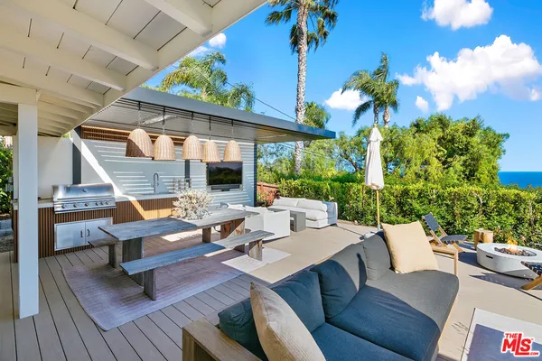 a view of a patio with couches and potted plants