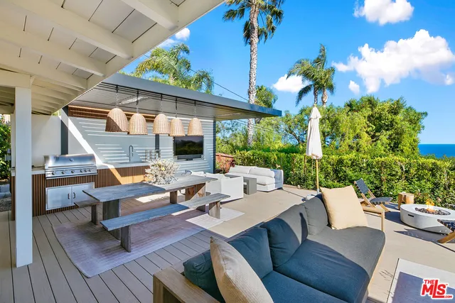 a view of a patio with couches and potted plants