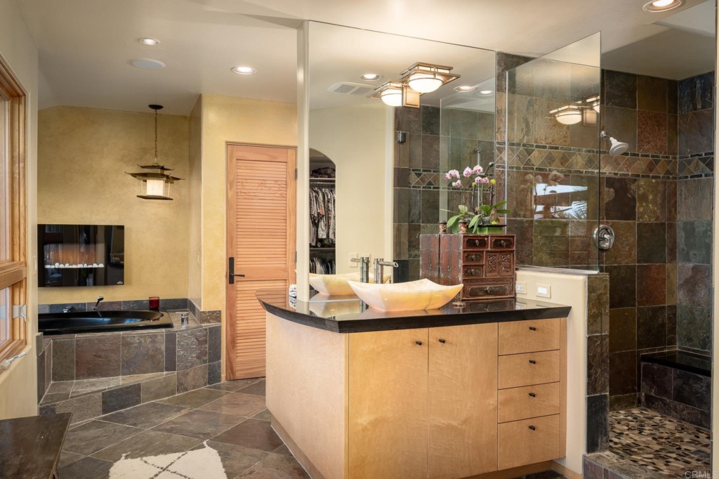 2892 Lone Jack Road Encinitas, CA 92024 - Photo 21 of 31 a kitchen with kitchen island granite countertop a sink and cabinets