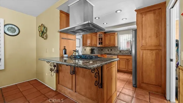 a kitchen with stainless steel appliances granite countertop a stove and a refrigerator