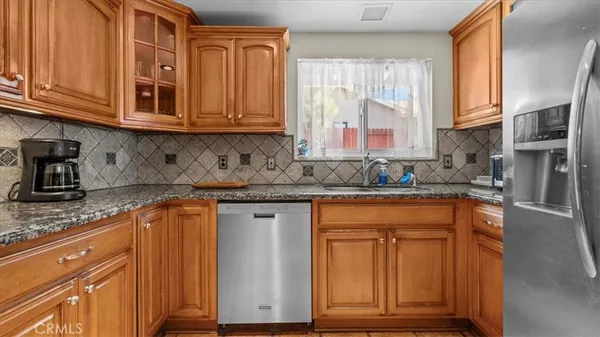 a kitchen with stainless steel appliances granite countertop a sink stove and cabinets