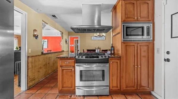 a kitchen with stainless steel appliances granite countertop a stove and a refrigerator