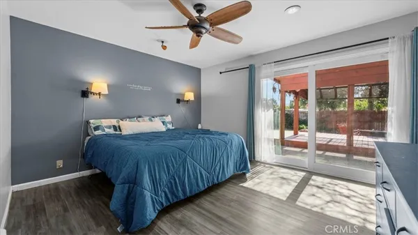 a bedroom with a bed and glass walk in closet