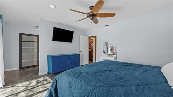 a bedroom with a bed and a flat screen tv