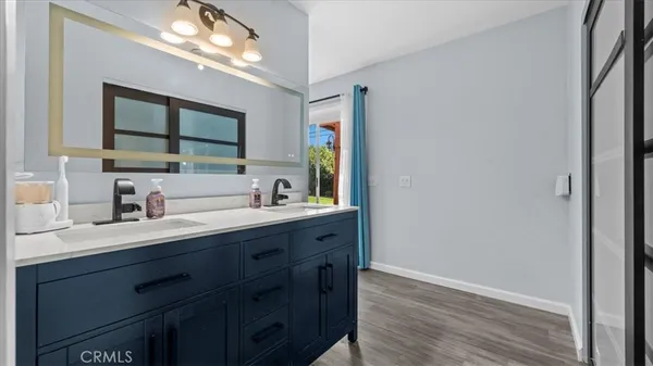 a bathroom with a double vanity sink and a mirror