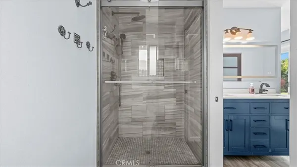 a bathroom with a shower a mirror and a sink