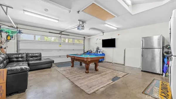 a living room with furniture a flat screen tv and a table