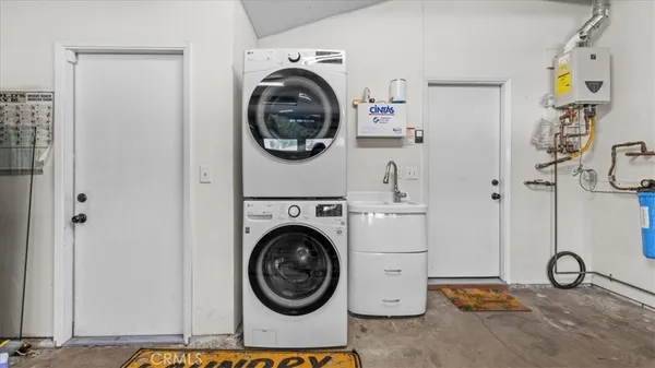 a view of a storage & utility room with a washer dryer