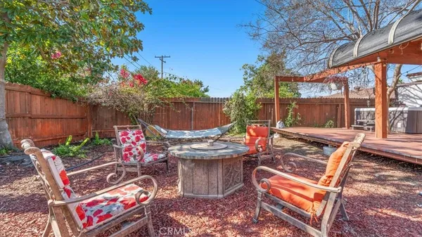 a view of a chairs and tables in the back yard of the house