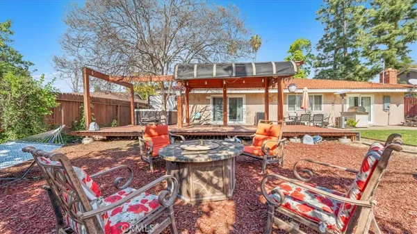 a view of a patio with couches table and chairs and potted plants