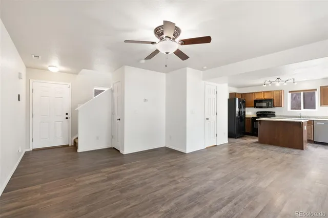 a view of a kitchen with a sink dishwasher refrigerator and cabinets