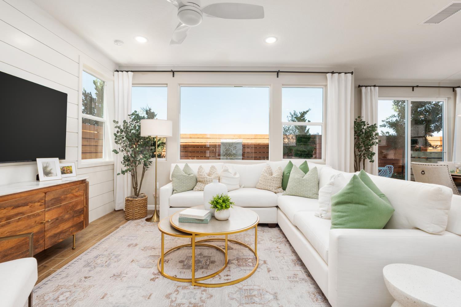 1538 Redbrick Lane Clovis, CA 93619 - Photo 6 of 34 a living room with furniture a large window and a flat screen tv