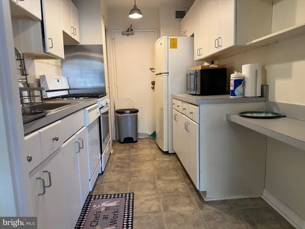a kitchen with stainless steel appliances a stove refrigerator sink and microwave