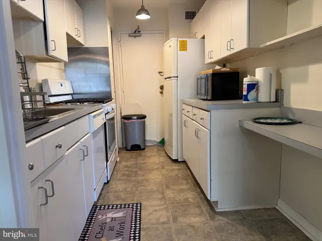 a kitchen with stainless steel appliances a stove refrigerator sink and microwave