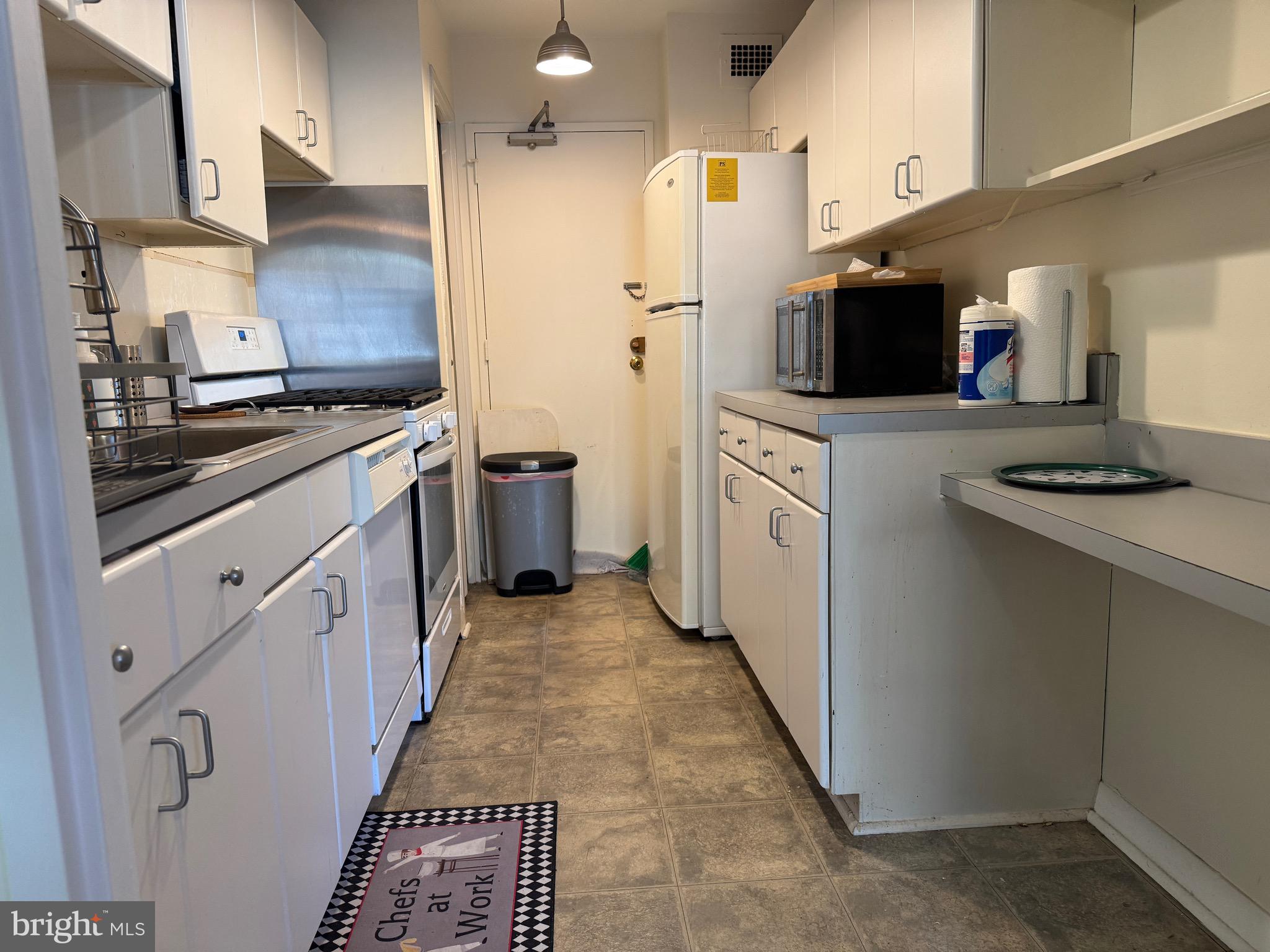 1900 Lyttonsville Road, Unit 417 Silver Spring, MD 20910 - Photo 7 of 15 a kitchen with stainless steel appliances a stove refrigerator sink and microwave