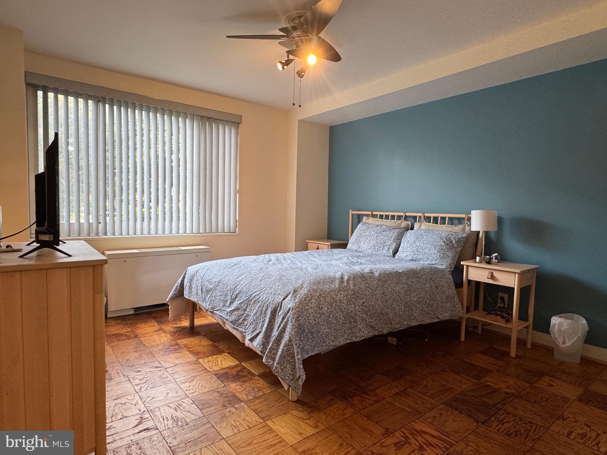 1900 Lyttonsville Road, Unit 417 Silver Spring, MD 20910 - Photo 9 of 15 a bedroom with a bed and a chandelier