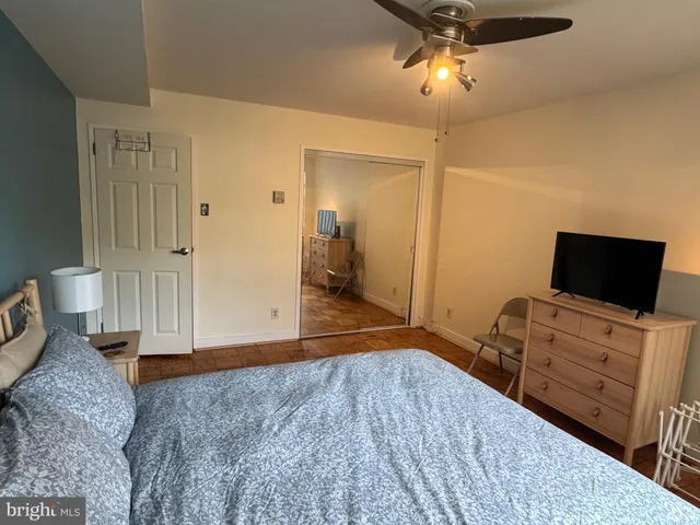 a bedroom with furniture and a flat screen tv