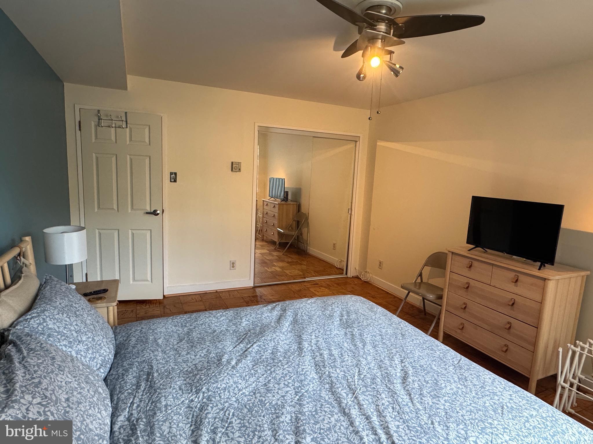 1900 Lyttonsville Road, Unit 417 Silver Spring, MD 20910 - Photo 10 of 15 a bedroom with furniture and a flat screen tv