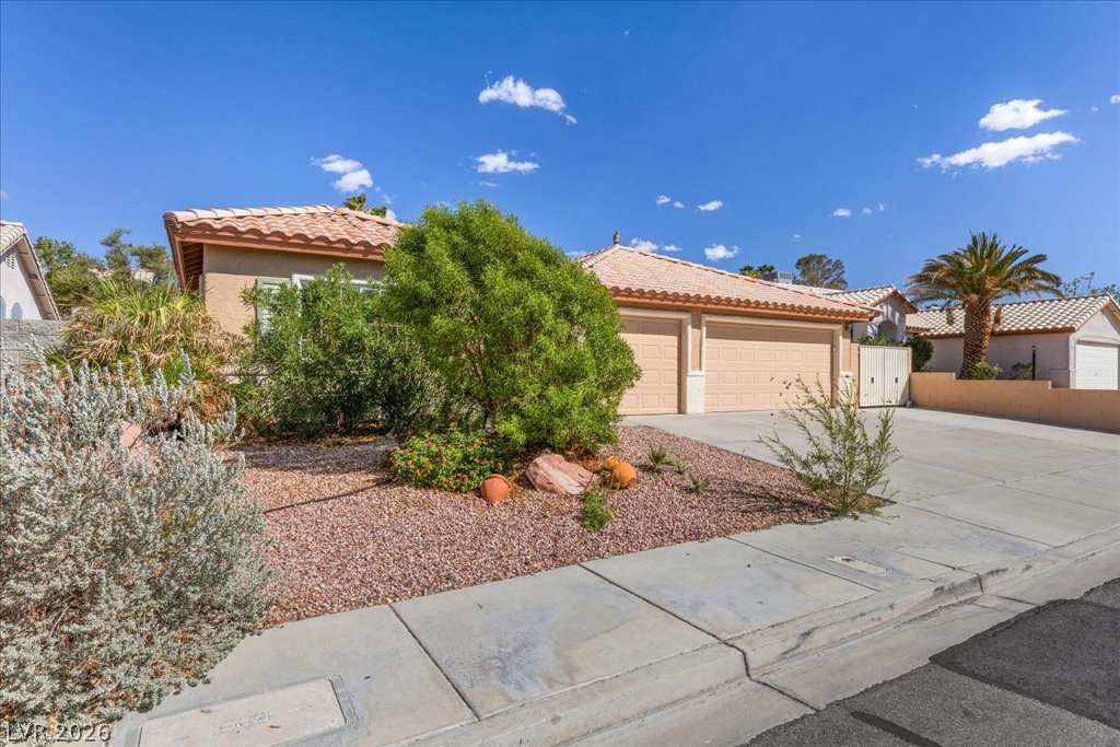 120 Ringlore Road Henderson, NV 89015 - Photo 3 of 58 Clay tile roofing and desert-friendly plantings create a timeless southwest exterior.