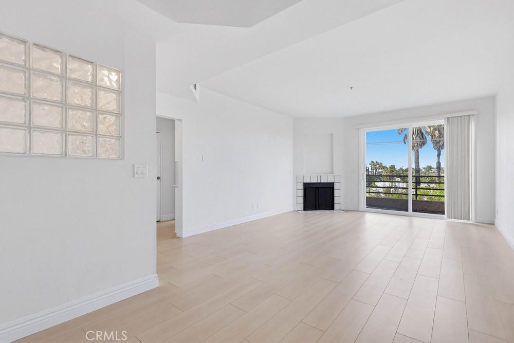 640 West 4th Street, Unit 401 Long Beach, CA 90802 - Photo 3 of 14 wooden floor in an empty room with a fireplace