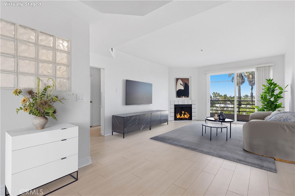 640 West 4th Street, Unit 401 Long Beach, CA 90802 - Photo 4 of 14 a living room with furniture a fireplace and a potted plant